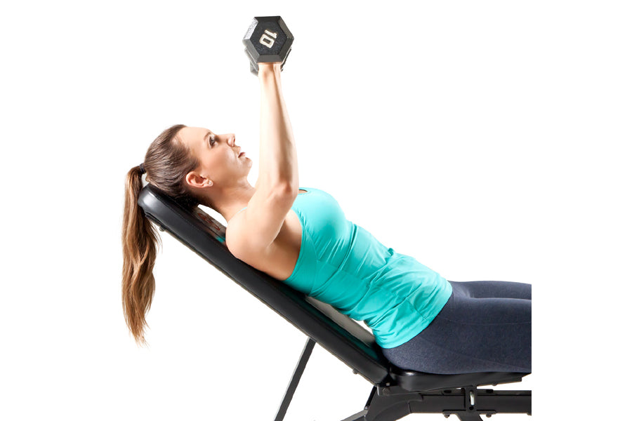 Woman in turquoise tank top performing dumbbell chest press on black Marcy utility weight bench