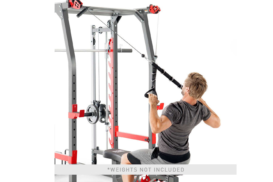 Gray and red metal Smith machine with cable pulley system, shown with male model performing lat pulldown exercise on white ba