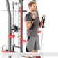 Man using gray and red Smith machine with cable attachments, wearing charcoal t-shirt and gray shorts