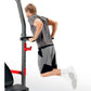 Man using gray and red Smith machine with black seat and foot platform on white background