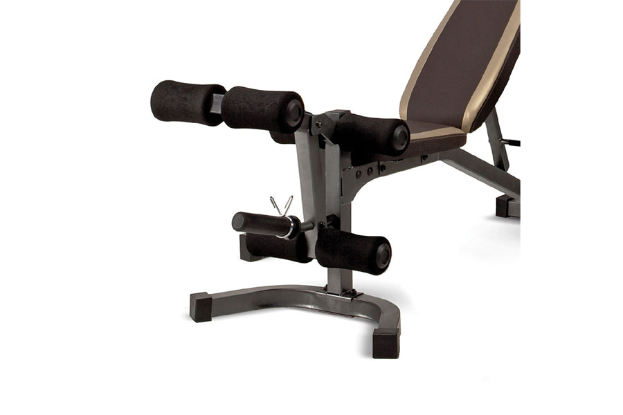 Black and tan weight bench with leg extension and curl attachment on white background