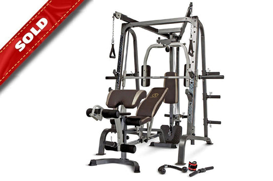 Multi-station Smith machine with gray steel frame, brown padded seat and backrest, leg press attachment, and weight plate peg