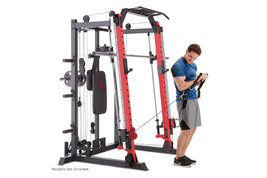 Man in blue shirt using red and black Smith machine cage system with cable attachment on white background