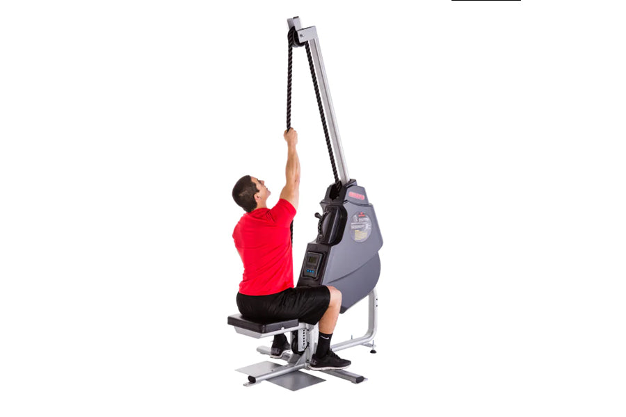Man in red shirt using gray and black Marpo VLT Compact Rope Trainer, pulling rope upward in seated position on white backgro
