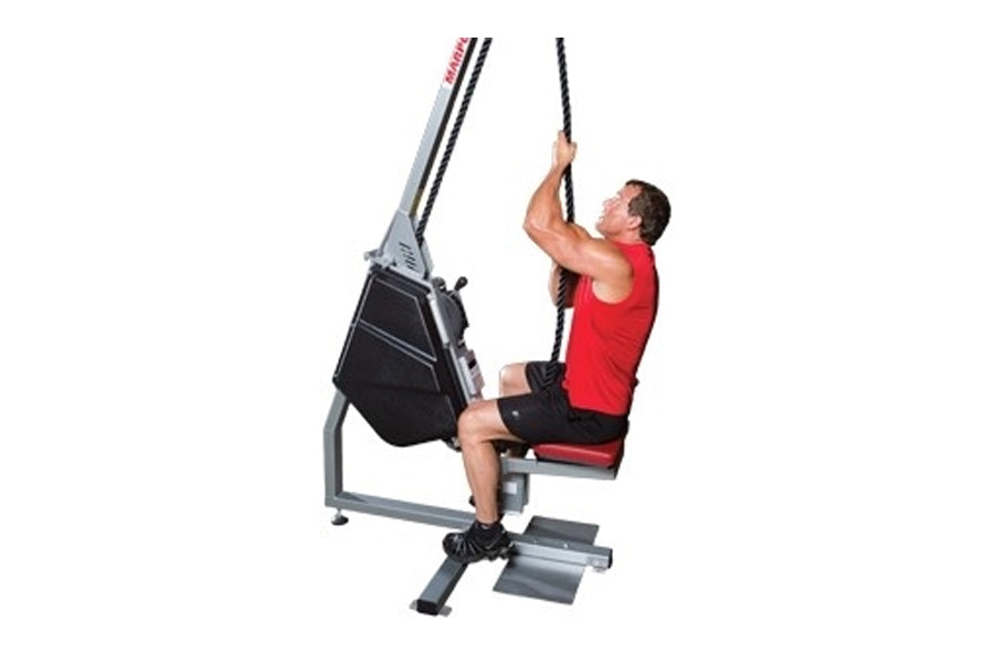 Man using gray and black vertical rope trainer machine with red seat, pulling rope overhead on white background