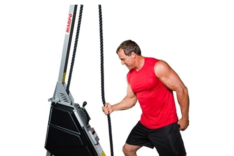 Man in red sleeveless shirt using Marpo VLT Compact Rope Trainer with black climbing ropes on white background