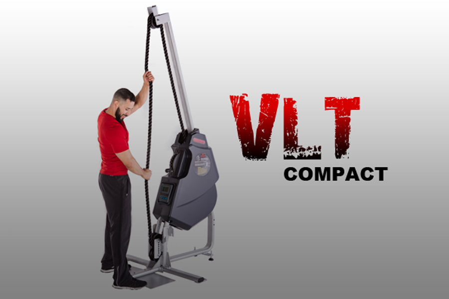 Man in red shirt using gray and black VLT Compact rope training machine on white background