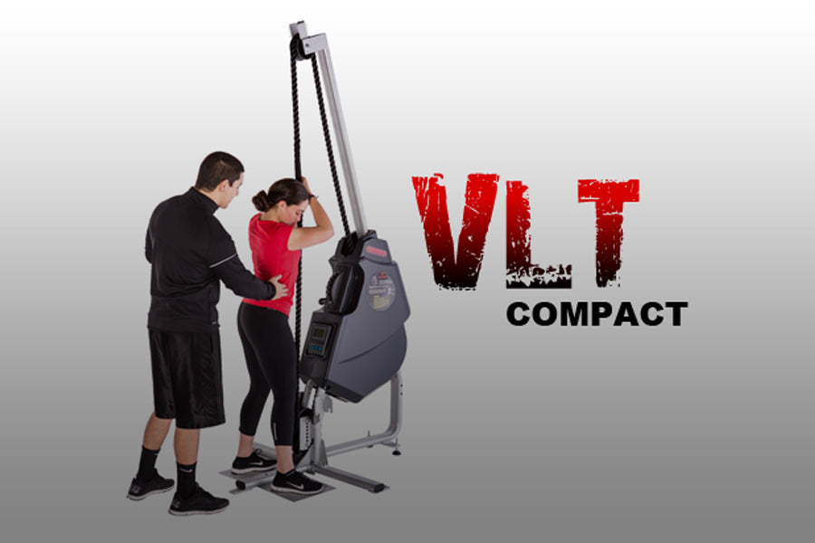 Two people using gray and black VLT Compact rope training machine with red "VLT COMPACT" logo on white background