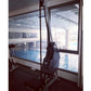 Marpo VLT Compact Rope Trainer in black with digital display, positioned by indoor pool with glass windows