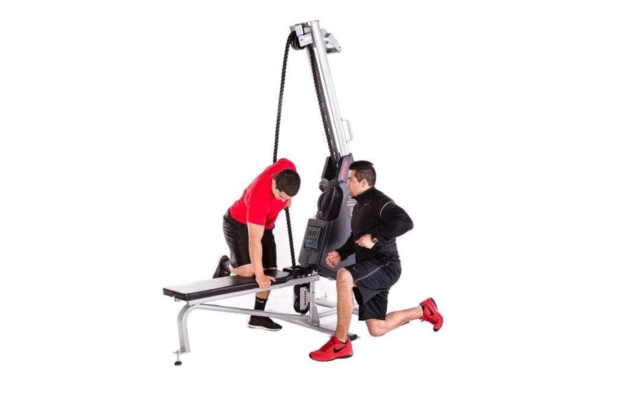 Two men using Marpo VMX 360 rope trainer with pulley system, one in red shirt pulling rope while kneeling, other in black jac
