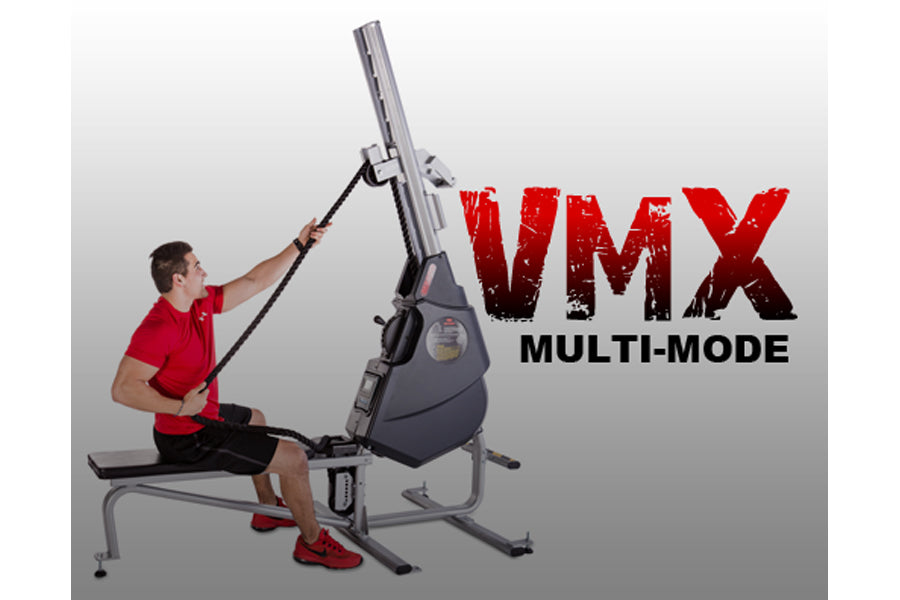 Man in red shirt using VMX multi-mode rope trainer machine with gray frame on white background