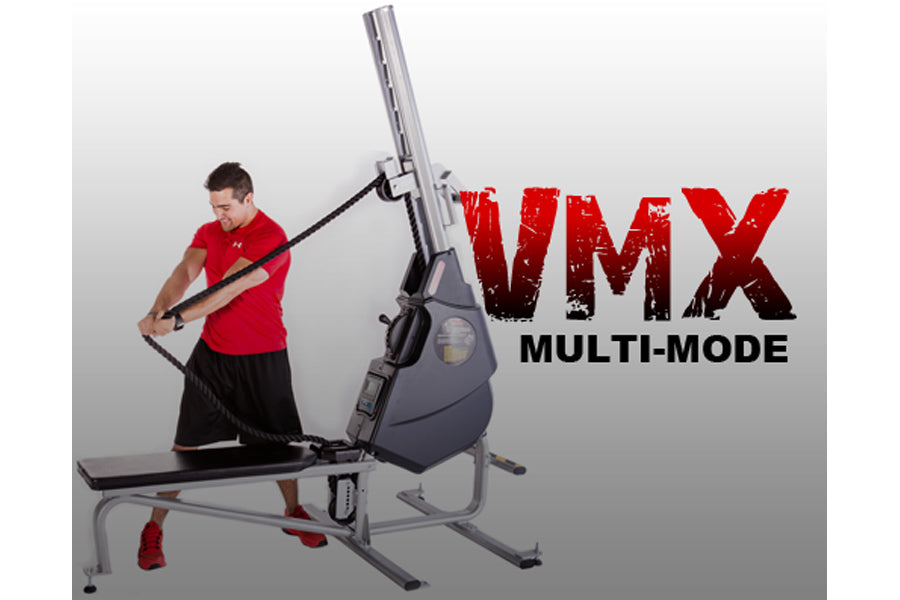 Man in red shirt using black and gray VMX multi-mode rope trainer machine on white background