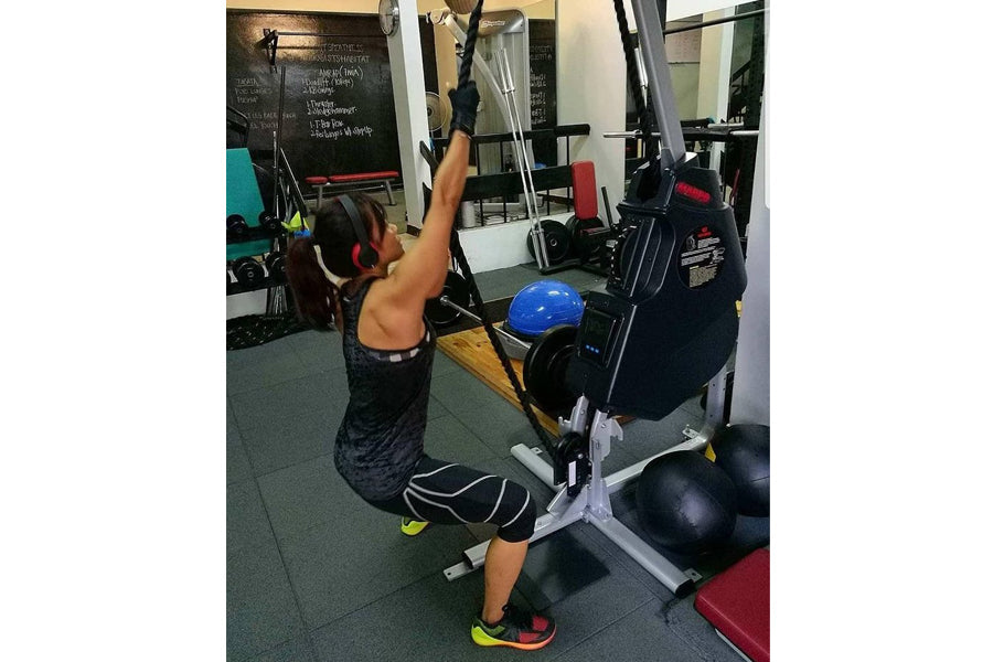 Person using Marpo VMX 360 rope trainer in gym setting with neon accents