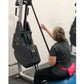Woman using black and gray Marpo VMX rope trainer with digital display, worn with black shirt and neon pink waistband