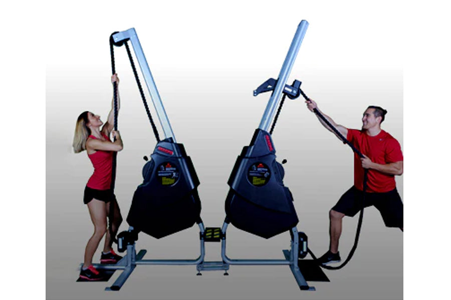 Woman in red shirt and man in red shirt using blue and black dual rope training machine with handles on white background