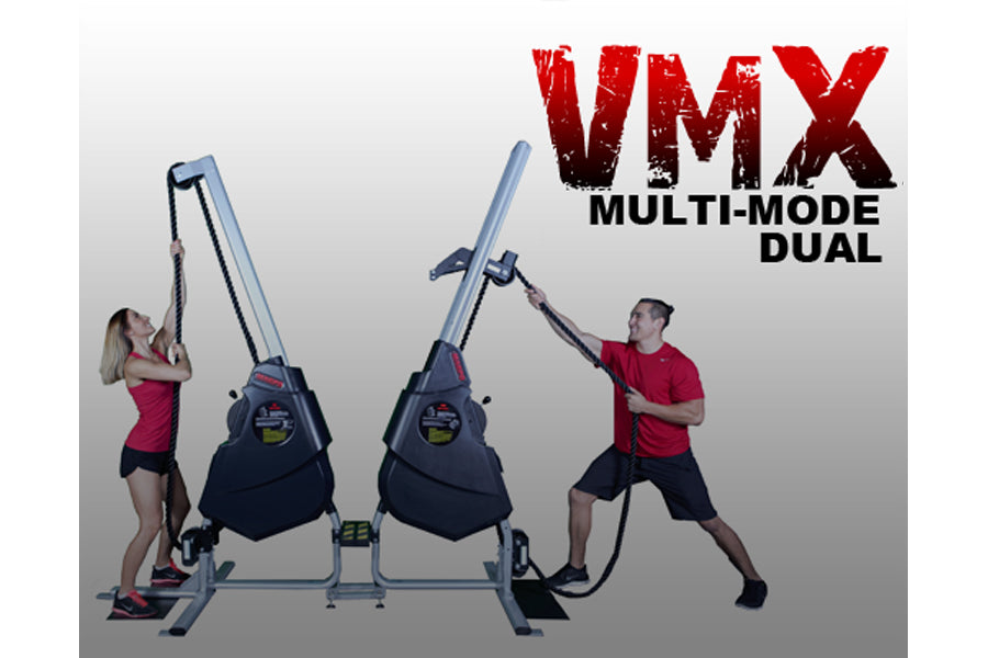 VMX Multi-Mode Dual rope trainer with dual heavy bags in black, shown with two models demonstrating exercises on gray backgro