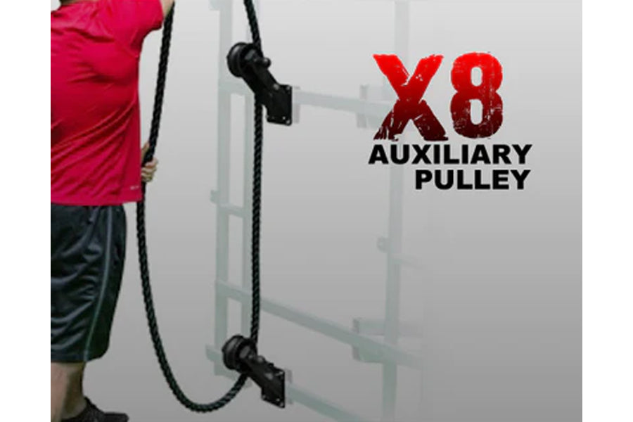 Person in pink shirt holding black rope attached to wall-mounted X8 auxiliary pulley system for training