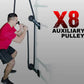 Man in magenta shirt using black rope attached to X8 auxiliary pulley wall-mounted trainer system