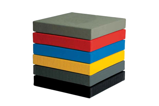 Stacked foam martial arts mats in gray, red, blue, yellow, dark gray, and black on white background