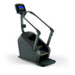 Black and gray stair climbing machine with digital display console, handrails, and yellow accents on stepping platform, on wh