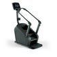 Black stair climbing machine with digital display console, handrails, and stepping platform on white background