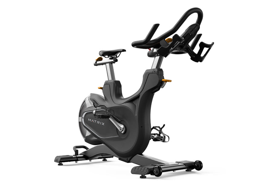 Matrix CXC indoor cycling bike with black frame, curved handlebars, and resistance wheel on white background