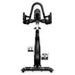 Matrix CXC indoor training bike with black frame, curved handlebars, and platform pedals, viewed from front on white backgrou