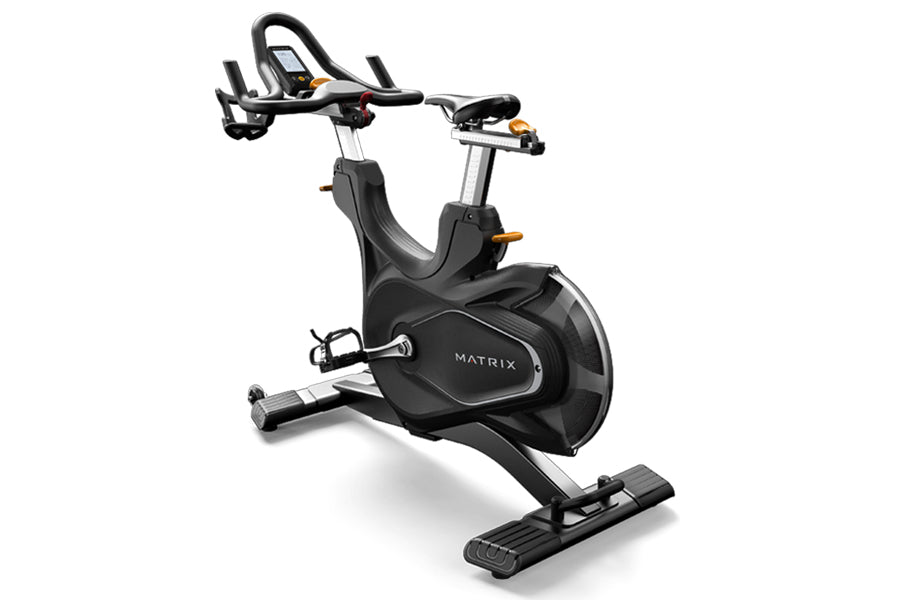 Matrix CXM black indoor training cycle with curved seat, handlebars with digital display, and extended footrest on white back