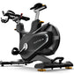 Matrix CXP indoor training cycle with black frame, dual handlebars, adjustable seat, and gold foot pedals on white background