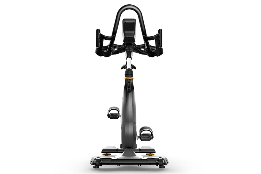 Matrix CXP indoor training cycle with black frame, curved handlebars, and foot pedals, viewed from front on white background