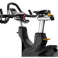 Black and silver stationary exercise bike with curved handlebars, digital display console, and gold accent handles on white b