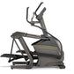 Black and gray Matrix E30 elliptical machine with yellow accent stripe, dual handles, and wide footplates on white background