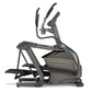 Matrix E50 elliptical machine in dark gray with yellow accent stripe and dual moving handlebars on white background