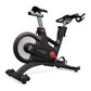 Matrix IC7 Indoor Club Group Cycle — angled rear view showing flywheel, adjustable saddle, multi-grip handlebars, red resistance knob, and arched stabilizing base