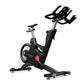 Matrix IC7 Indoor Club Group Cycle — side profile view showing multi-grip handlebars, adjustable saddle, red resistance knob, and transport wheels