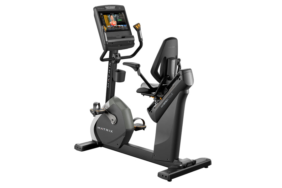 Matrix Performance Touch Hybrid Cycle recumbent exercise bike with black frame, digital display console, and gold accents on 
