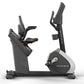 Matrix Performance Touch Hybrid Cycle recumbent stationary bike with black frame, gray seat, and digital display console on w