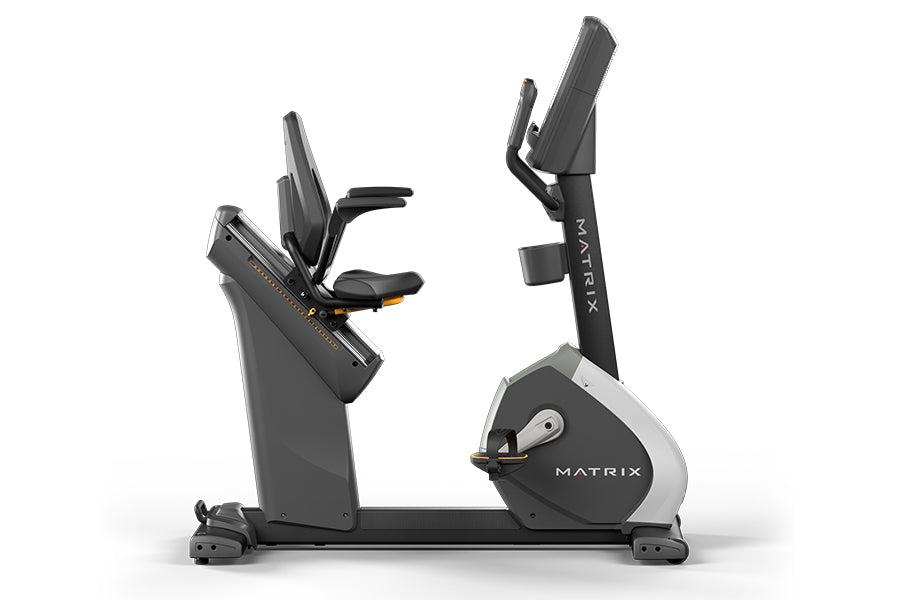 Matrix Performance Touch Hybrid Cycle recumbent stationary bike with black frame, gray seat, and digital display console on w