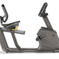 Matrix R30 recumbent exercise bike with gray frame, padded seat, handlebars, and upright display console on white background