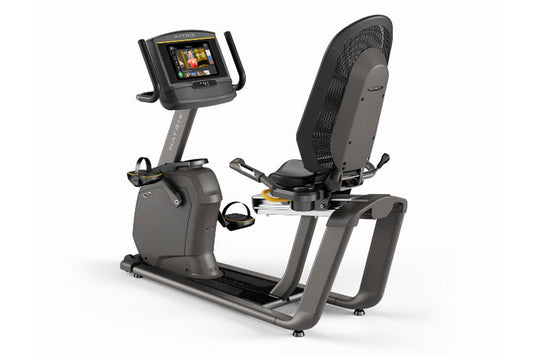 Matrix R50 recumbent exercise bike with black mesh backrest and gray frame, digital touchscreen console on adjustable arm, on