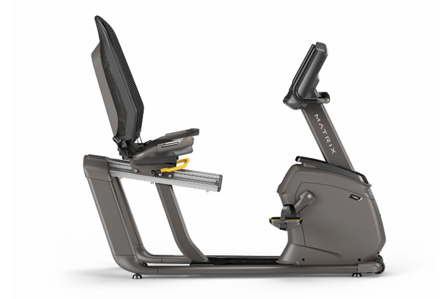 Matrix R50 recumbent exercise bike with gray frame, black mesh backrest, and digital display console on white background