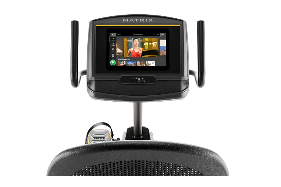 Matrix R50 recumbent exercise bike with touchscreen display showing fitness app, black frame with gray seat, on white backgro