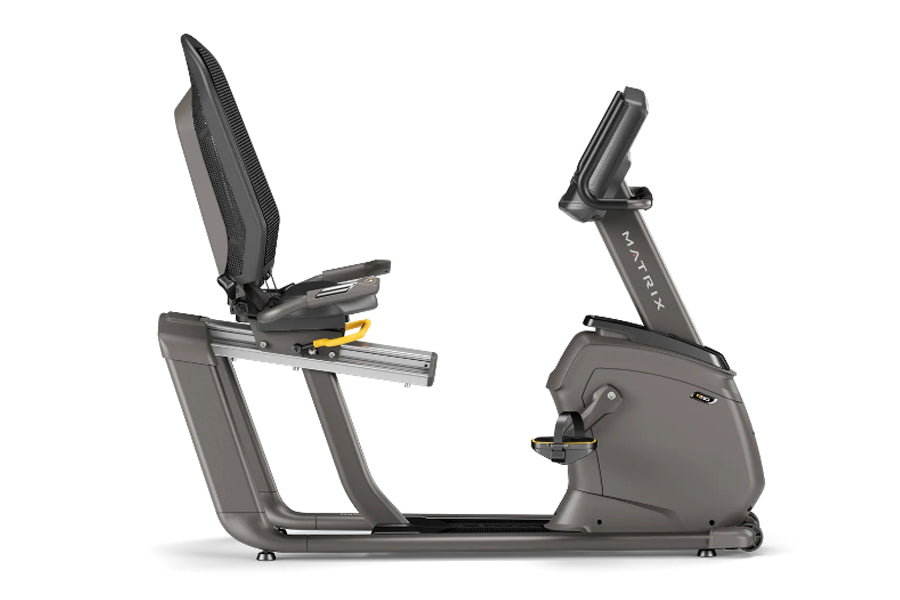 Matrix R50 recumbent exercise bike with gray frame, black padded seat, and digital display console on white background
