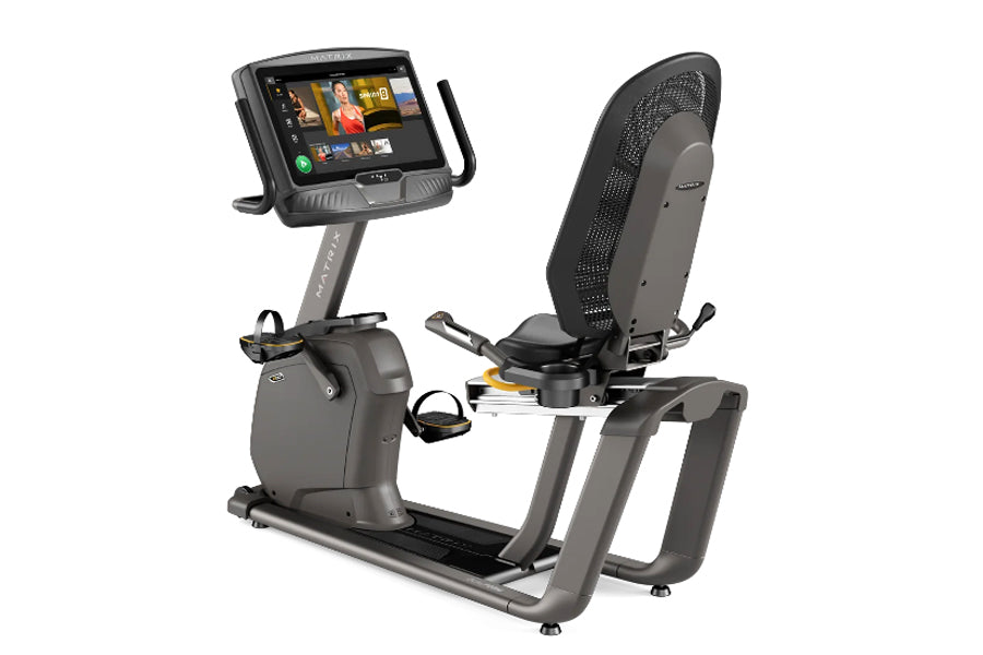 Matrix R50 recumbent exercise bike with gray frame, black mesh seat back, and touchscreen display mounted on vertical column,