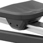 Black padded seat with textured surface mounted on white aluminum rail of rowing machine