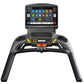 Matrix T130 treadmill with black frame, touchscreen console displaying app icons, and yellow accent buttons on handlebars, fr