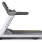 Matrix T130 treadmill with white frame, gray console, and black running deck on white background