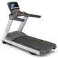 Matrix T130 motorized treadmill with black running deck, silver frame, digital console display, and hand grips, isolated on w