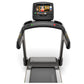Matrix T50 black treadmill with touchscreen console displaying workout content, front view on white background