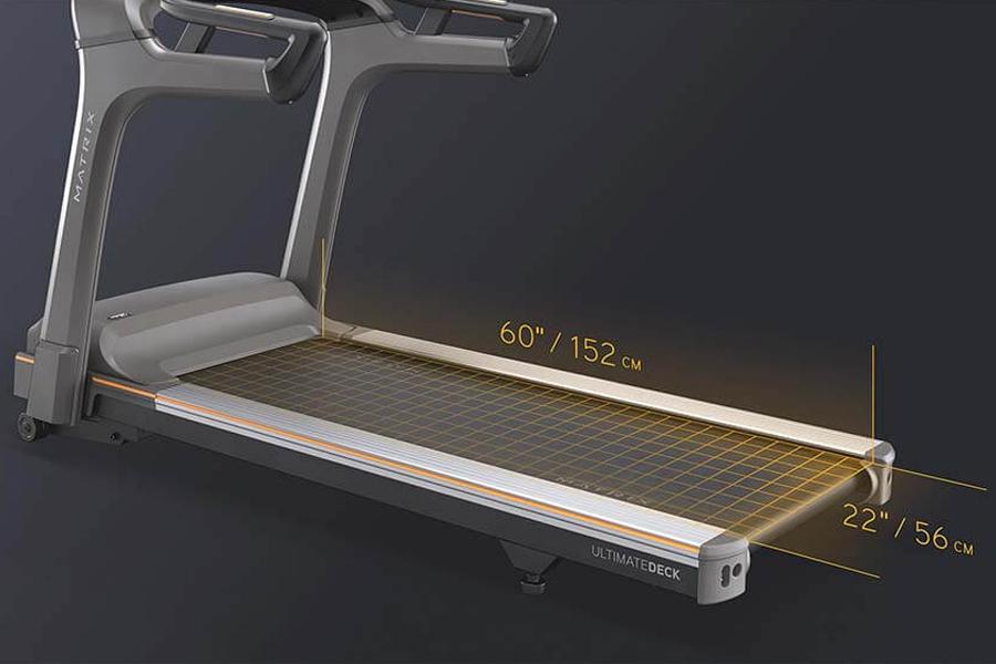 Matrix T75 treadmill with gray frame, black running deck with grid pattern, and digital display showing 60" by 22" dimensions